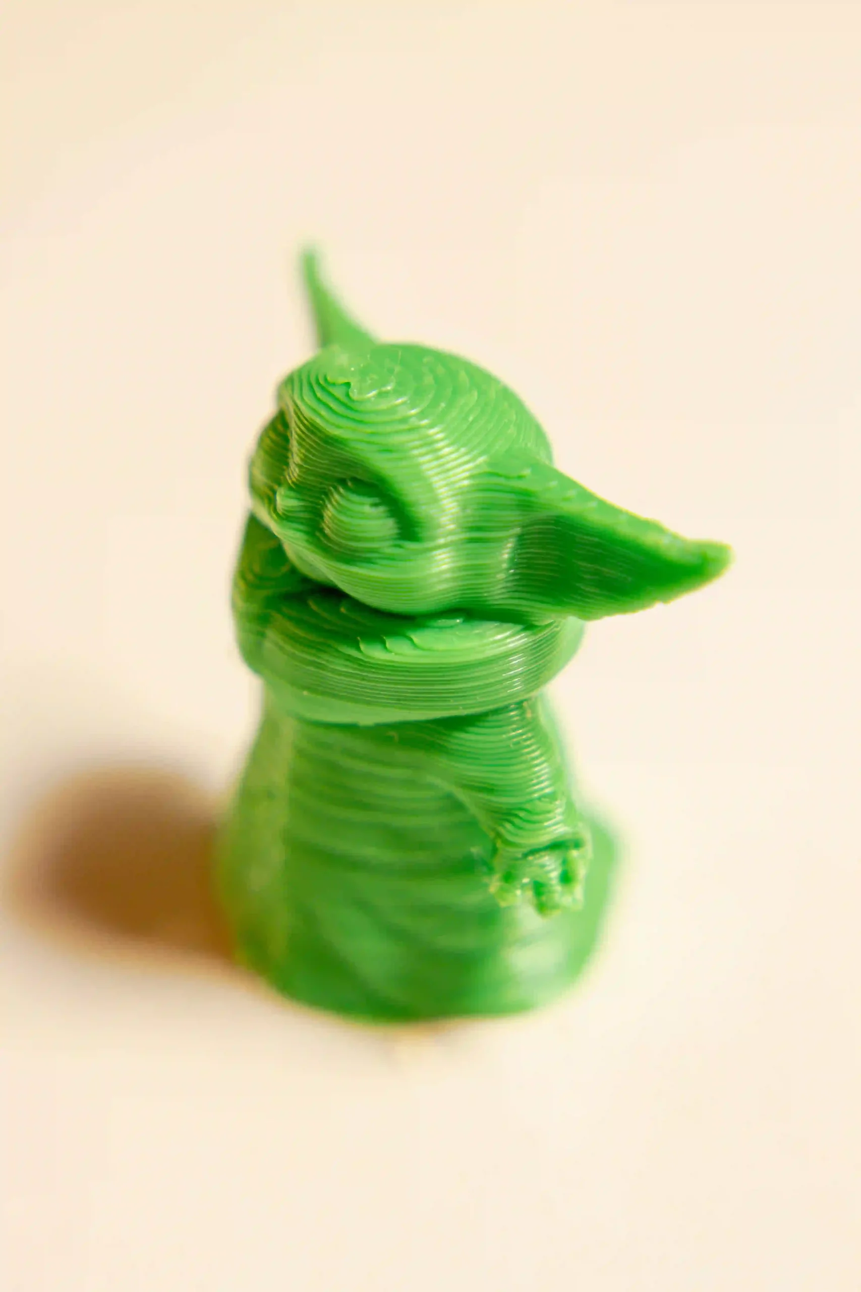 A 3D printing of baby Yoda in green colour